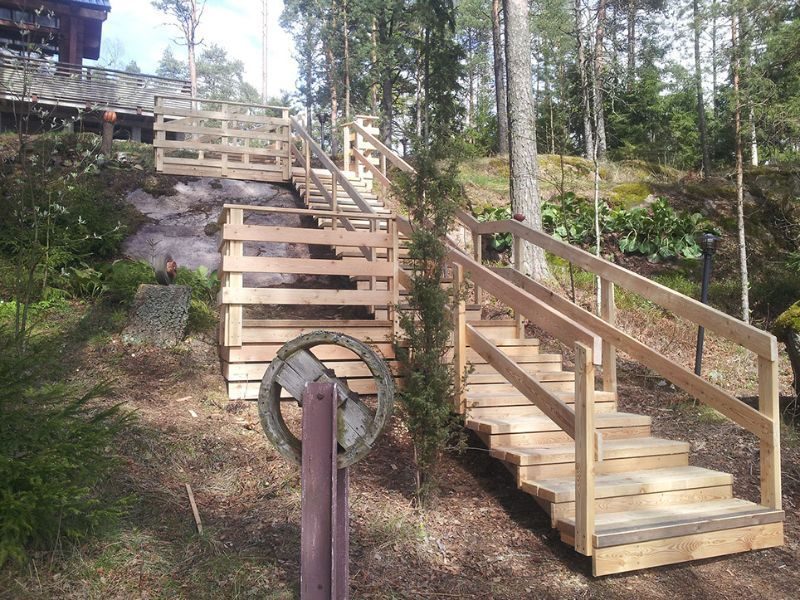 Puiset ulkoportaat metsäisessä rinteessä